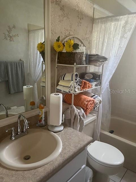 9430 Nakoma Way, Unit 12 Weeki Wachee, FL 34613 - Photo 13 of 20 a bathroom with a sink mirror vanity and toilet