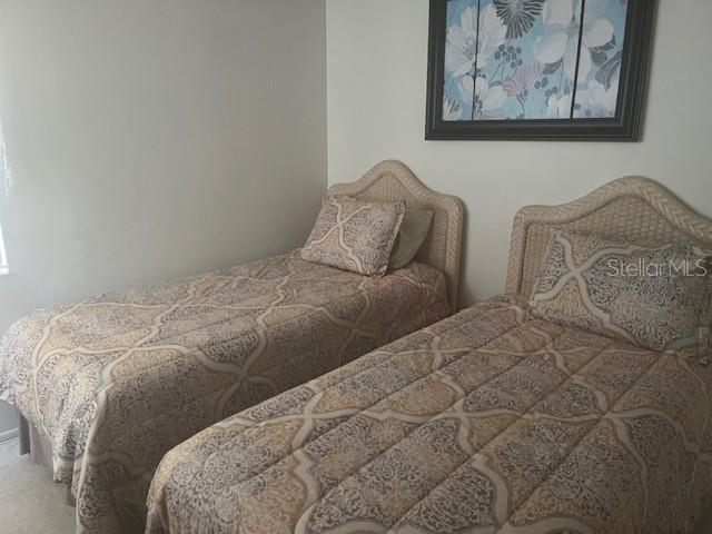 9430 Nakoma Way, Unit 12 Weeki Wachee, FL 34613 - Photo 14 of 20 a bed with two twin beds in it