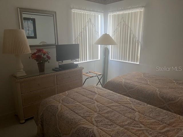 9430 Nakoma Way, Unit 12 Weeki Wachee, FL 34613 - Photo 15 of 20 a bedroom with a bed and a window