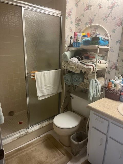9430 Nakoma Way, Unit 12 Weeki Wachee, FL 34613 - Photo 16 of 20 a white toilet sitting next to a bathroom sink
