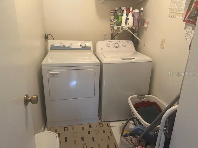 9430 Nakoma Way, Unit 12 Weeki Wachee, FL 34613 - Photo 17 of 20 a utility room with dryer and washer