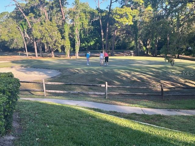 9430 Nakoma Way, Unit 12 Weeki Wachee, FL 34613 - Photo 18 of 20 a view of a park with swings and a large tree