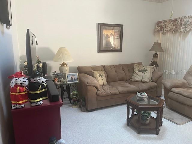 9430 Nakoma Way, Unit 12 Weeki Wachee, FL 34613 - Photo 4 of 20 a living room with furniture flowerpot and a window