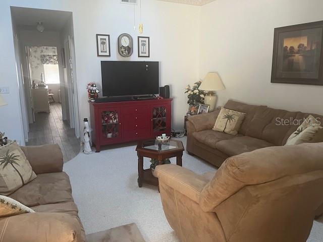 9430 Nakoma Way, Unit 12 Weeki Wachee, FL 34613 - Photo 6 of 20 a living room with furniture and a flat screen tv
