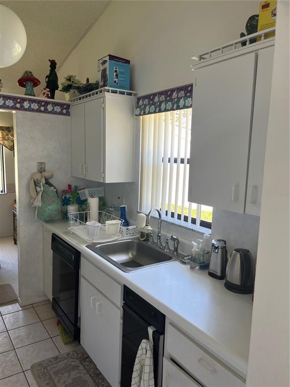 9430 Nakoma Way, Unit 12 Weeki Wachee, FL 34613 - Photo 7 of 20 a kitchen with stainless steel appliances a sink a counter cabinets and a window