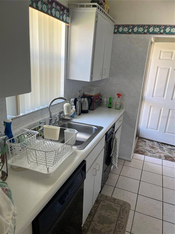 9430 Nakoma Way, Unit 12 Weeki Wachee, FL 34613 - Photo 9 of 20 a kitchen with a sink a stove and cabinets