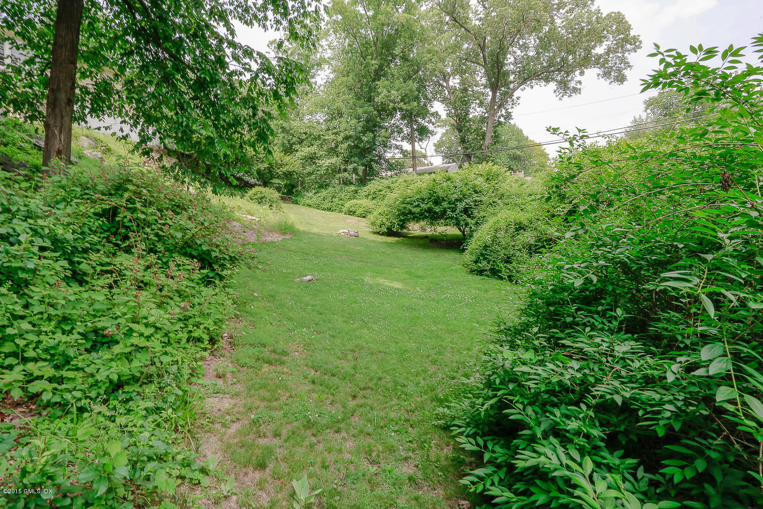 84 Cognewaugh Road Cos Cob, CT 06807 - Photo 14 of 18 a view of a lush green space