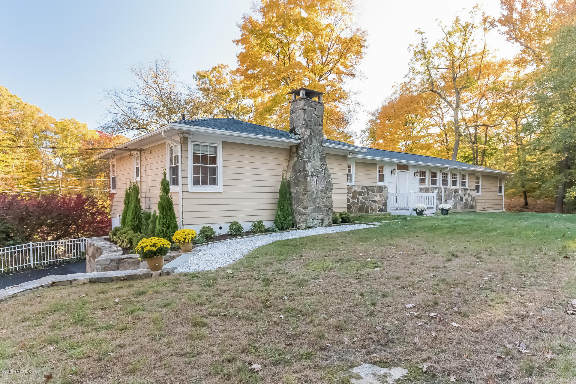84 Cognewaugh Road Cos Cob, CT 06807 - Photo 8 of 18 a view of a house with backyard and a tree