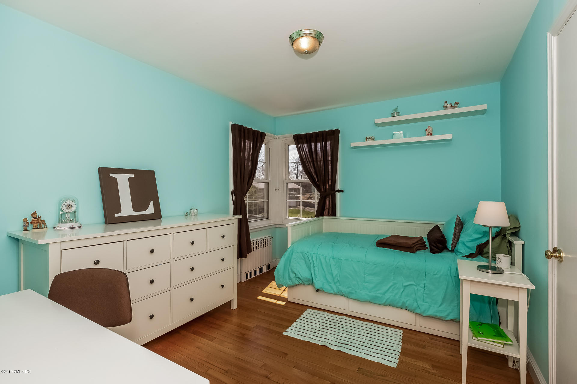 84 Cognewaugh Road Cos Cob, CT 06807 - Photo 9 of 18 a bedroom with a bed and a dresser in it