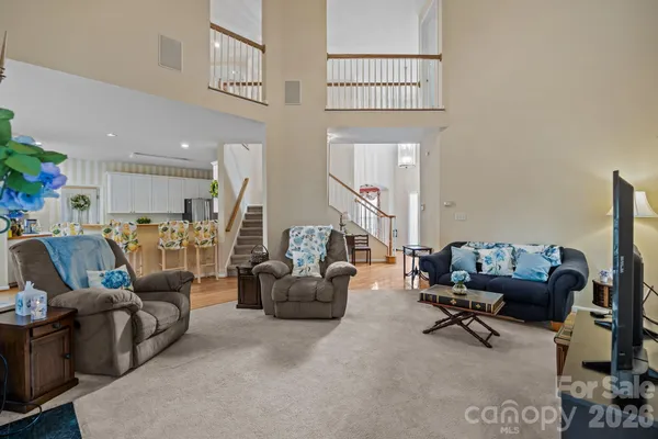 a living room with furniture and a gym machine