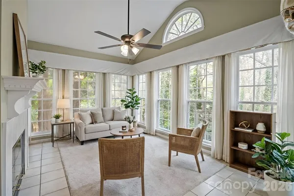 a living room with furniture and a floor to ceiling window