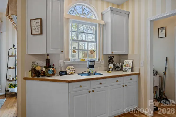 a kitchen with stainless steel appliances white cabinets and a refrigerator