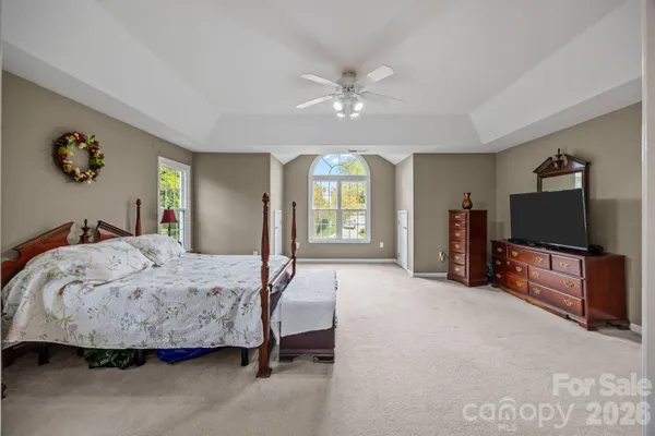 a bedroom with a bed and a flat screen television