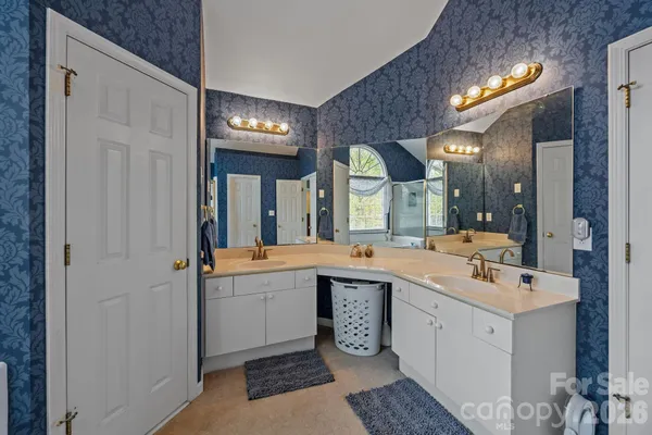 a view of a double sink and a mirror in a room