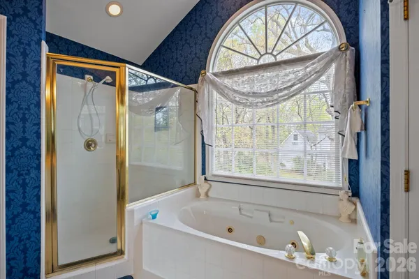 a bathroom with a tub and a window