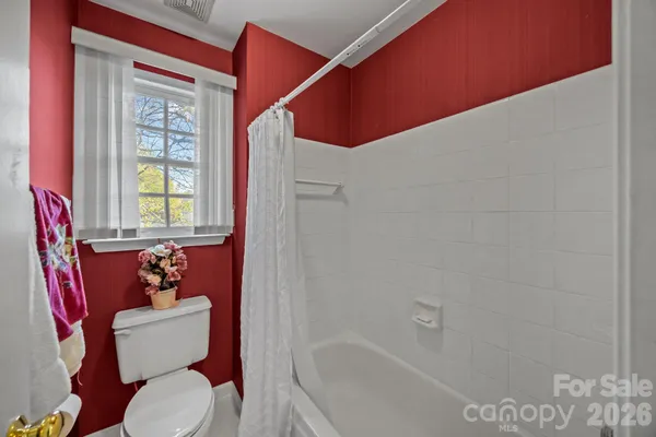 a bathroom with a toilet and a bathtub