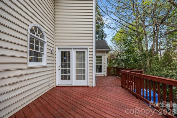 a view of a house with wooden deck