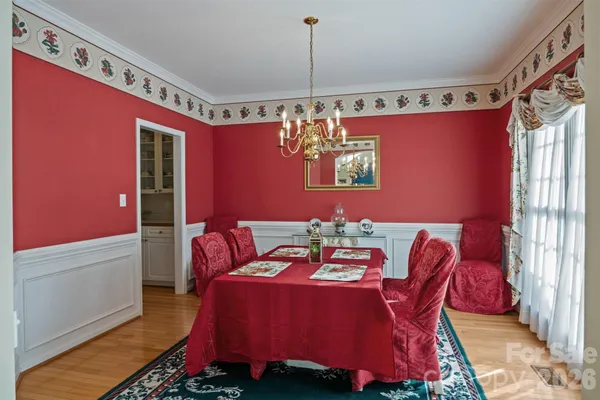 a view of a dining room with furniture and chandelier