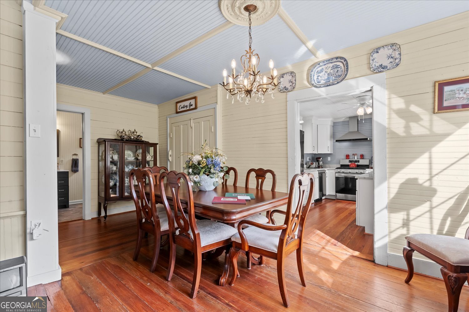 6644 East Cadley Road Norwood, GA 30821 - Photo 22 of 53 a view of a dining room with furniture wooden floor and chandelier