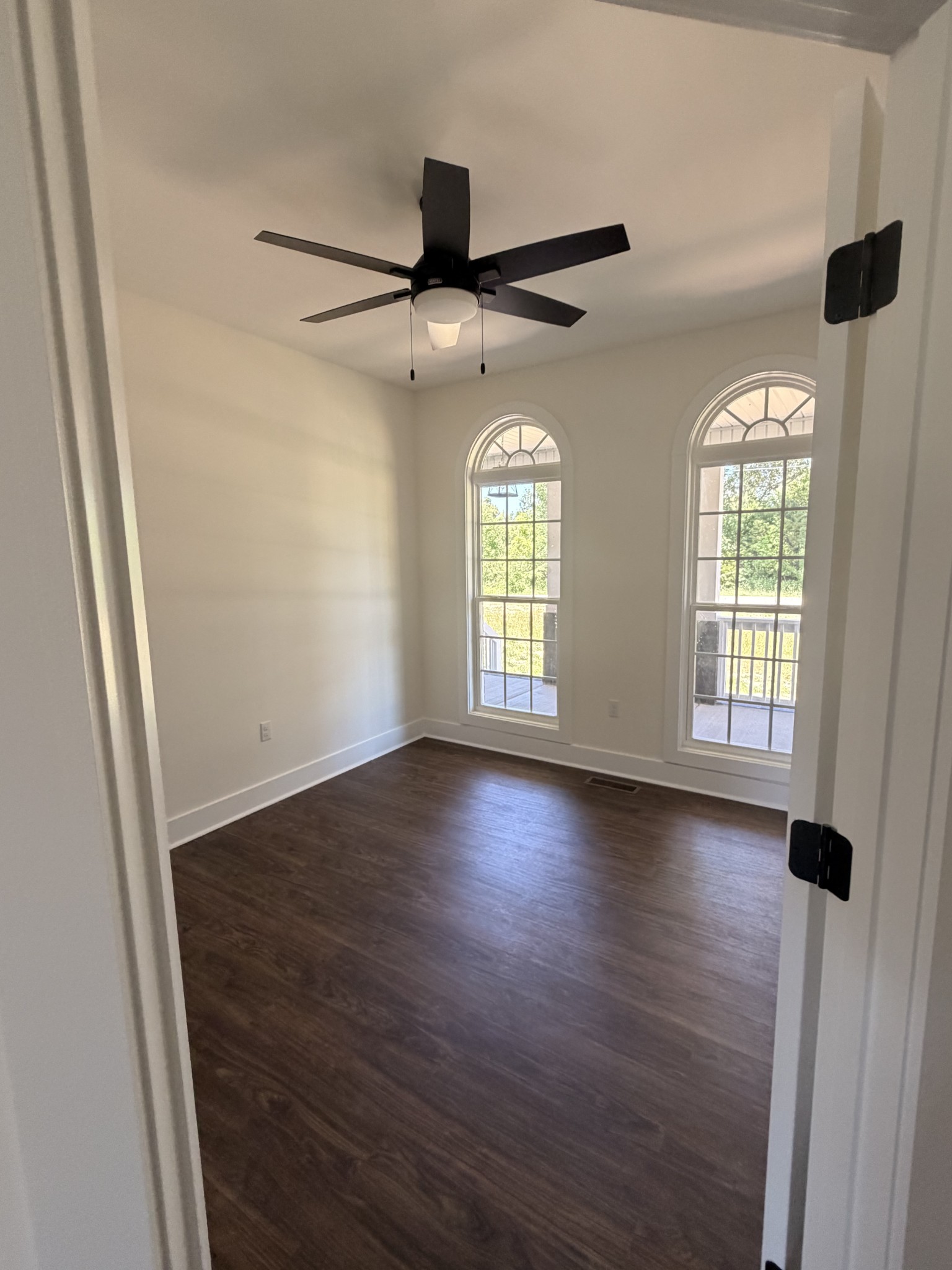 527 Old Hopkinsville Road Cadiz, KY 42211 - Photo 15 of 31 an empty room with wooden floor and windows