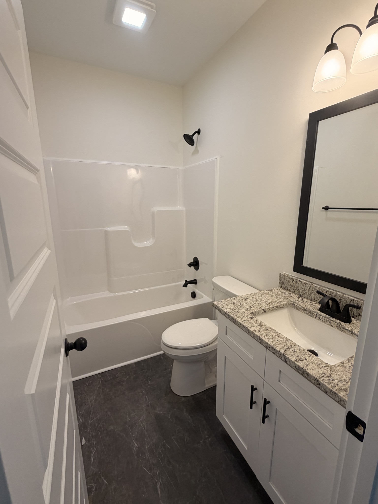 527 Old Hopkinsville Road Cadiz, KY 42211 - Photo 20 of 31 a bathroom with a granite countertop sink toilet a mirror and shower