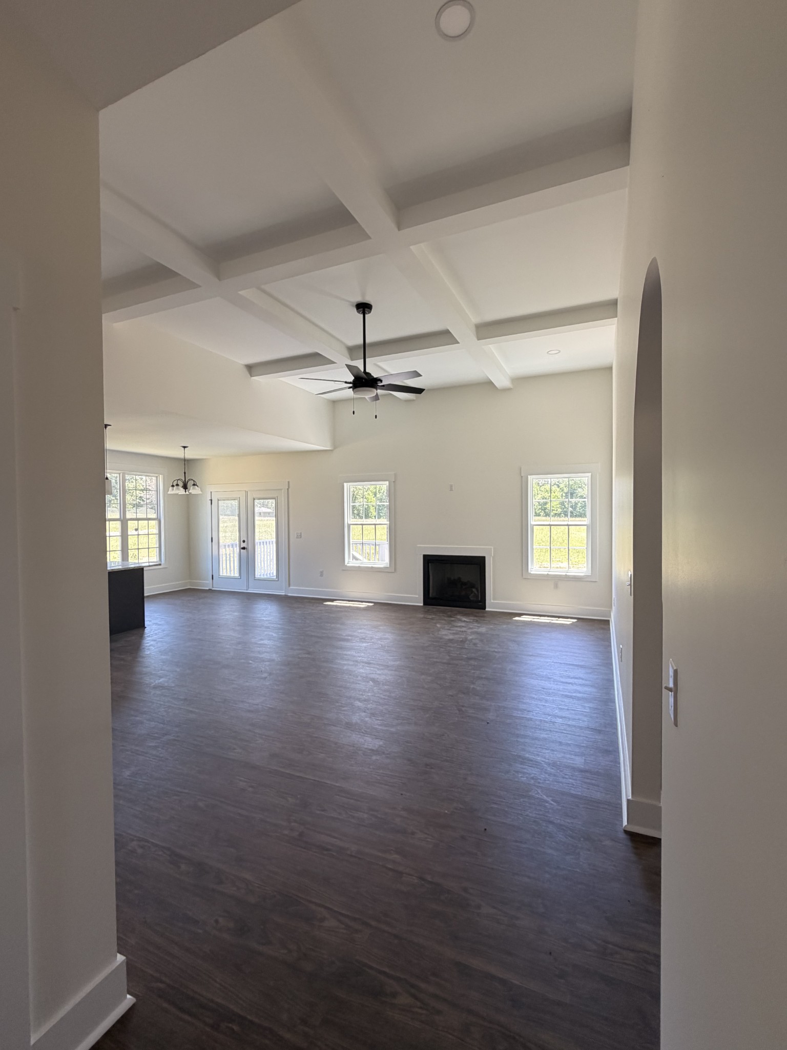 527 Old Hopkinsville Road Cadiz, KY 42211 - Photo 9 of 31 an empty room with wooden floor chandelier and windows