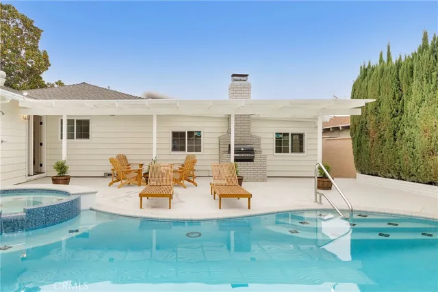 a view of a house with a wooden fence