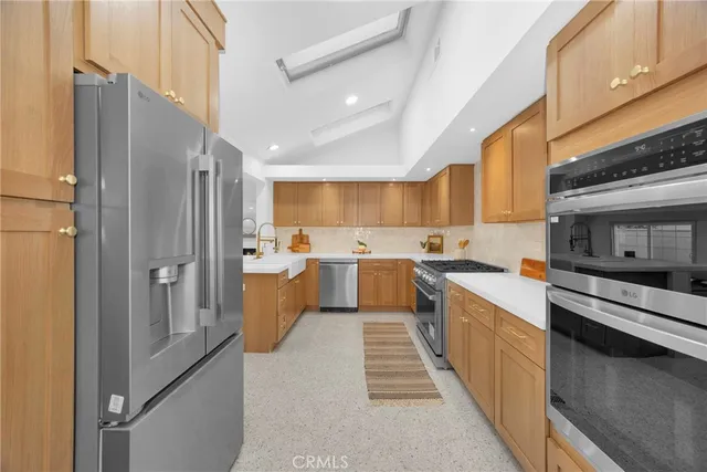 a kitchen with stainless steel appliances granite countertop a stove and a sink