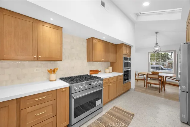 a kitchen with stainless steel appliances a sink stove and cabinets