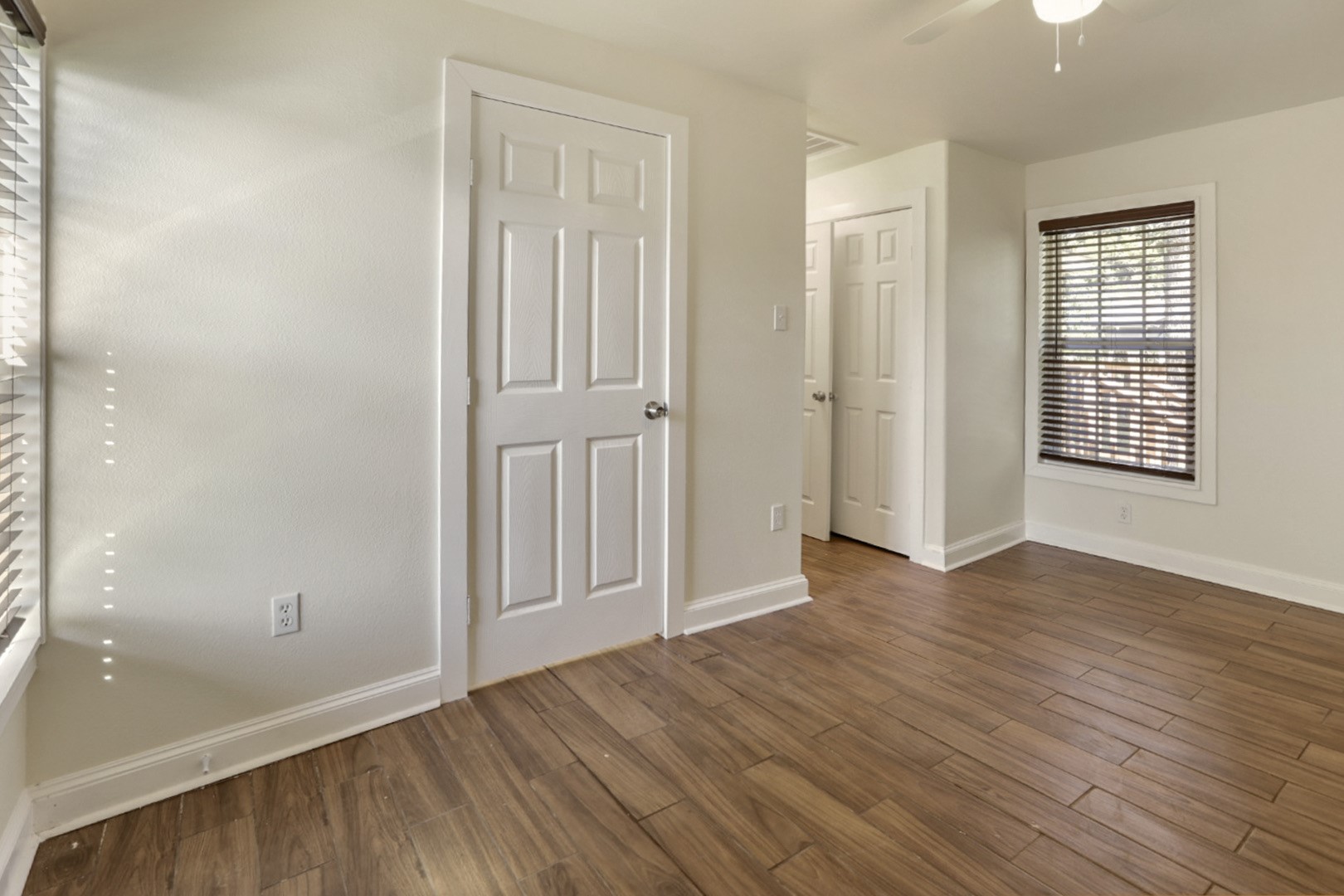 4606 Antha Street Houston, TX 77016 - Photo 22 of 27 an empty room with wooden floor and windows