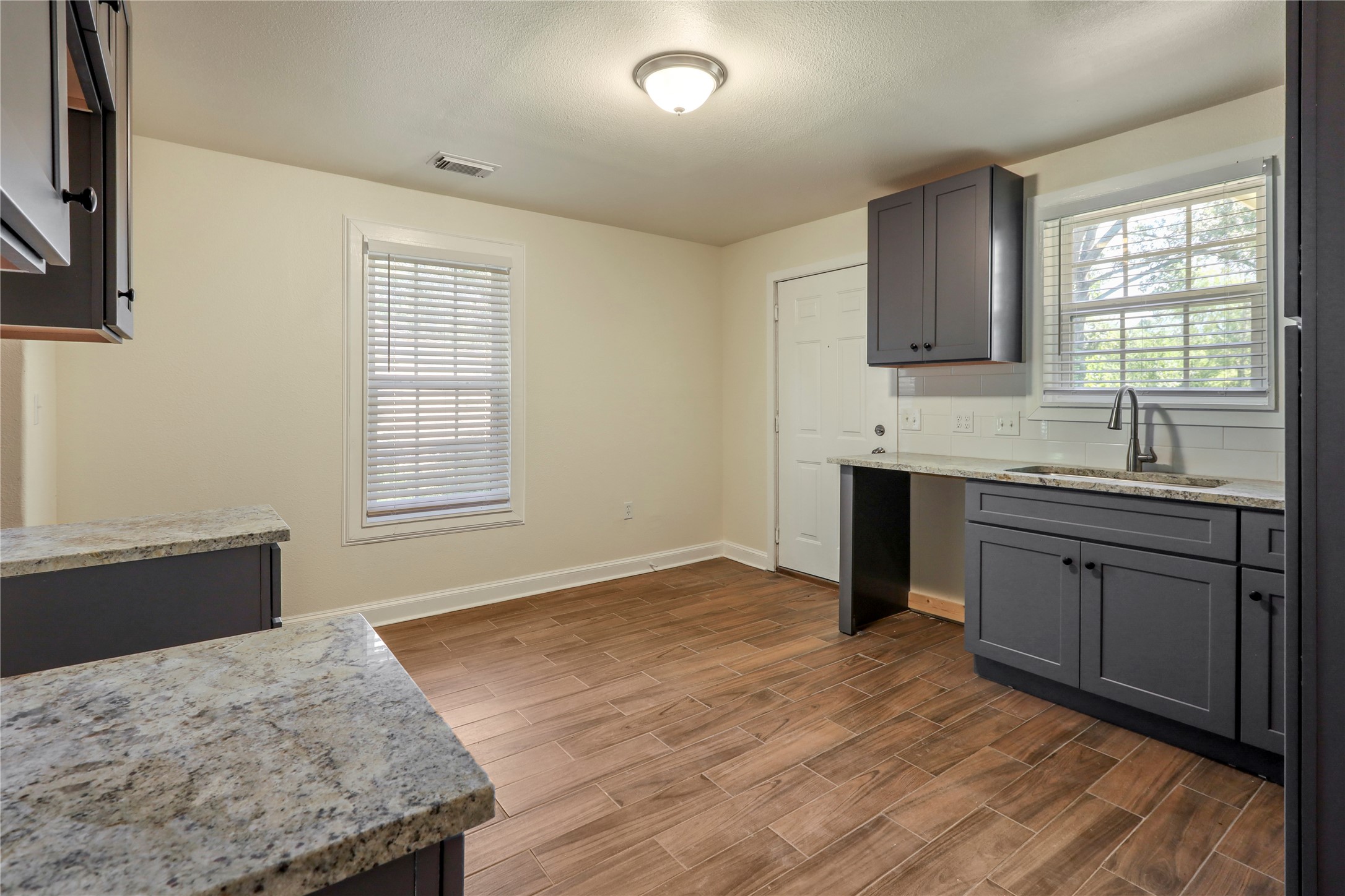 4606 Antha Street Houston, TX 77016 - Photo 26 of 27 a kitchen with a sink stove and cabinets
