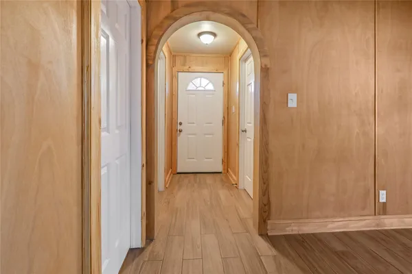 a view of a hallway with wooden floor