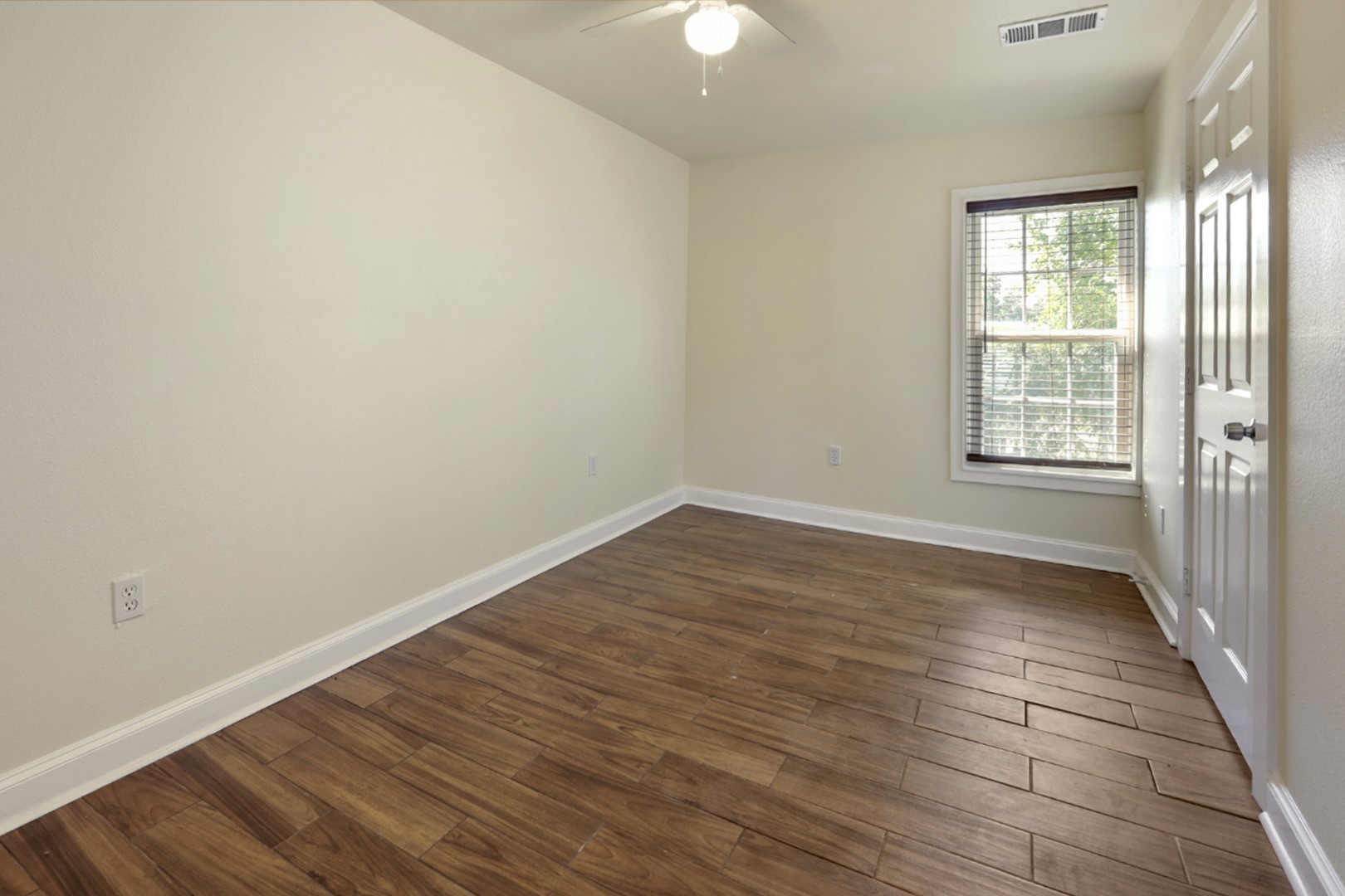 4606 Antha Street Houston, TX 77016 - Photo 6 of 27 wooden floor in an empty room with a window