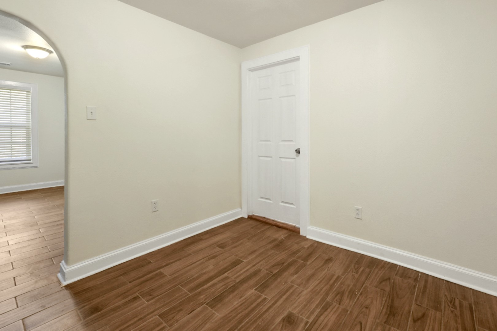 4606 Antha Street Houston, TX 77016 - Photo 8 of 27 an empty room with wooden floor and windows