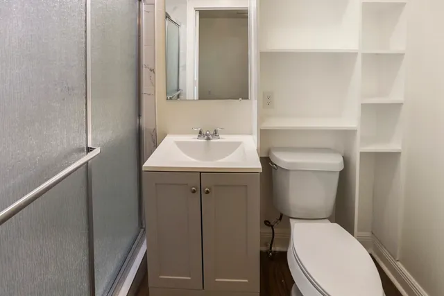 a white toilet sitting next to a bathroom sink