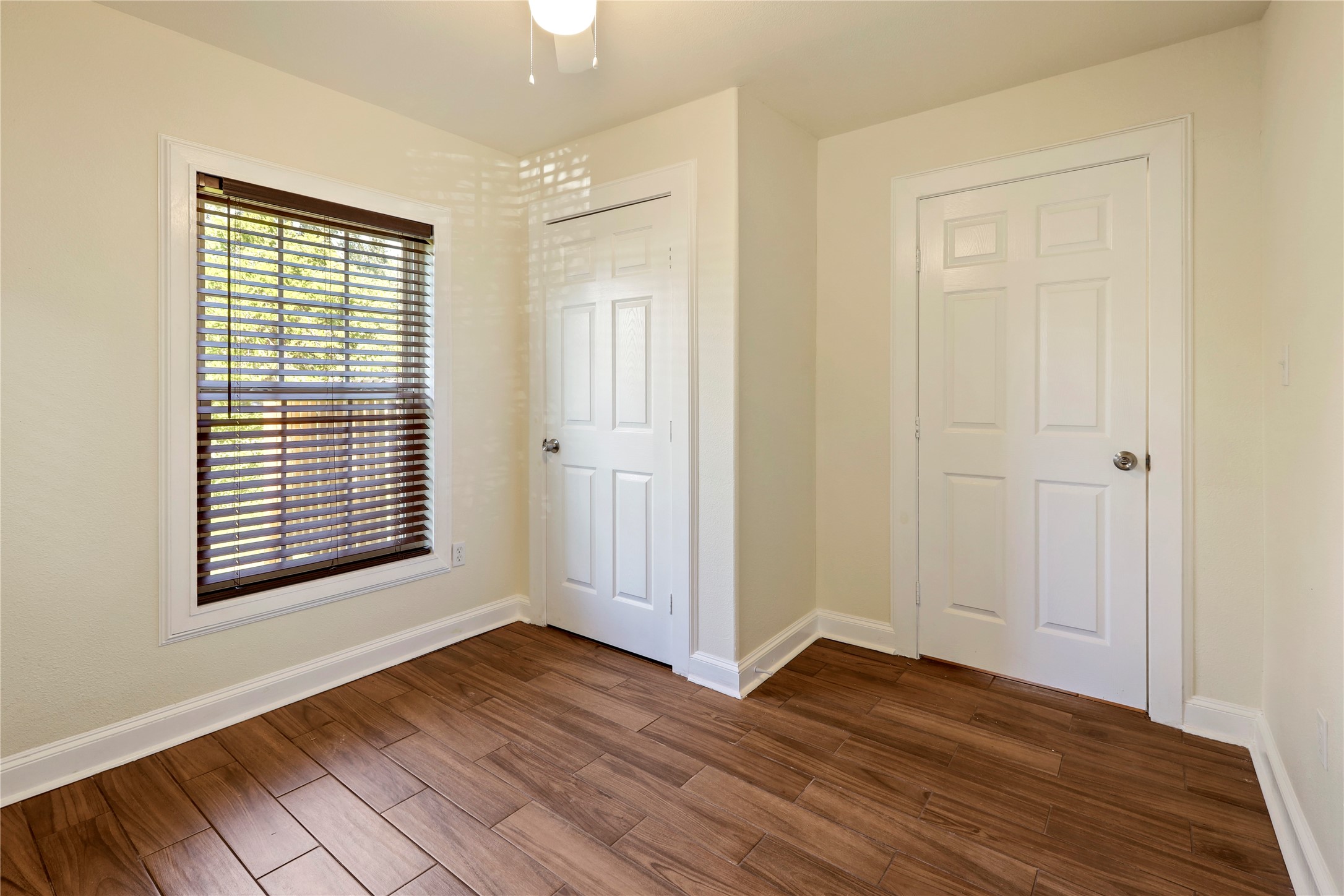 4606 Antha Street Houston, TX 77016 - Photo 10 of 27 a view of an empty room with wooden floor and a window