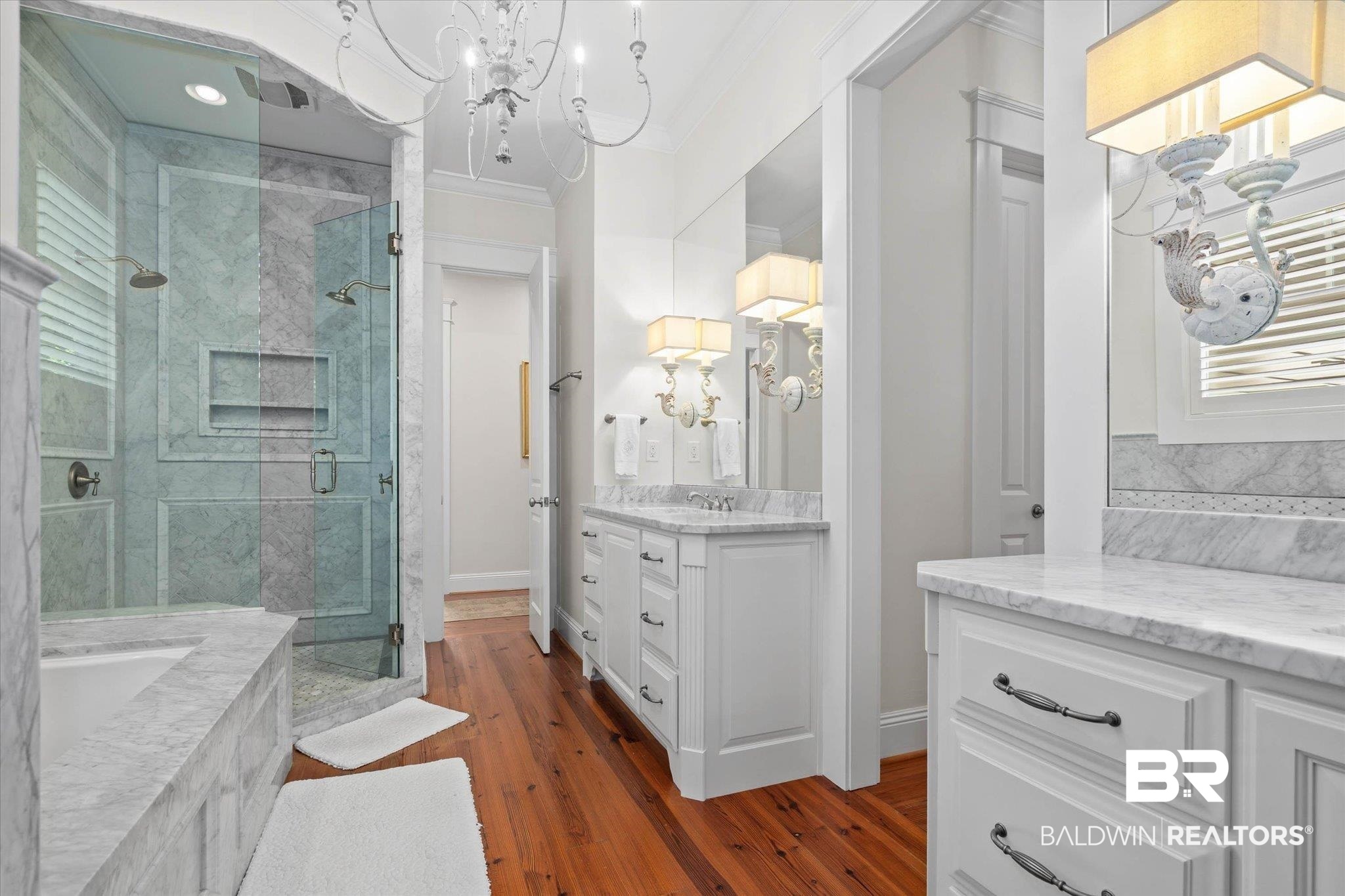 3813 Austill Lane Mobile, AL 36608 - Photo 13 of 37 Bathroom featuring a glass-enclosed shower with multiple showerheads, a built-in tub with marble-finish surround, dual vanities with marble-finish countertops, and wood-finish flooring
