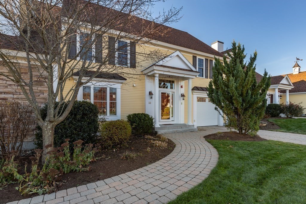 22 English Commons: 12 Boston Street, Unit 22 Topsfield, MA 01983 - Photo 1 of 41 a front view of a house with a garden