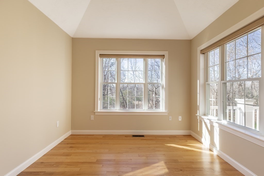 22 English Commons: 12 Boston Street, Unit 22 Topsfield, MA 01983 - Photo 15 of 41 an empty room with wooden floor and windows