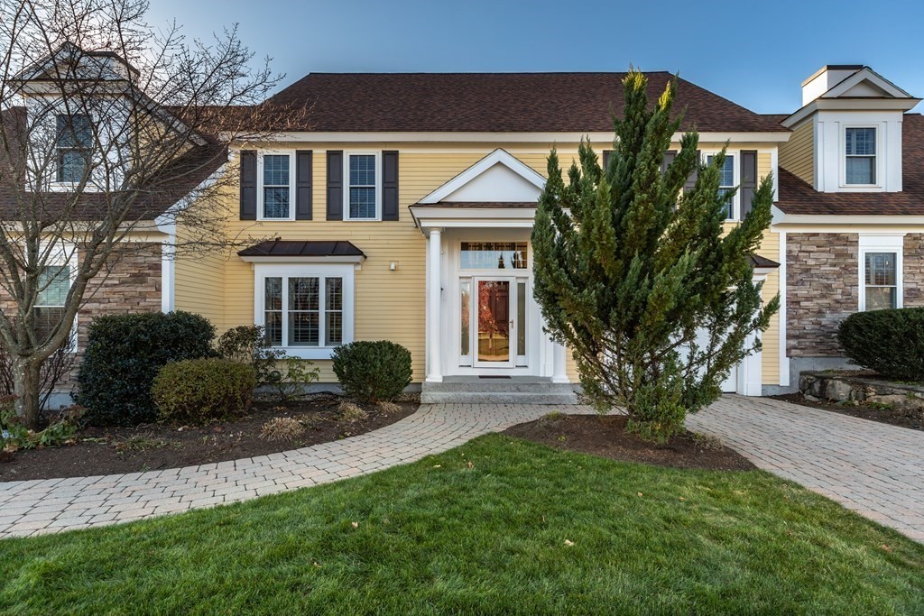 22 English Commons: 12 Boston Street, Unit 22 Topsfield, MA 01983 - Photo 2 of 41 a front view of a house with a yard and potted plants