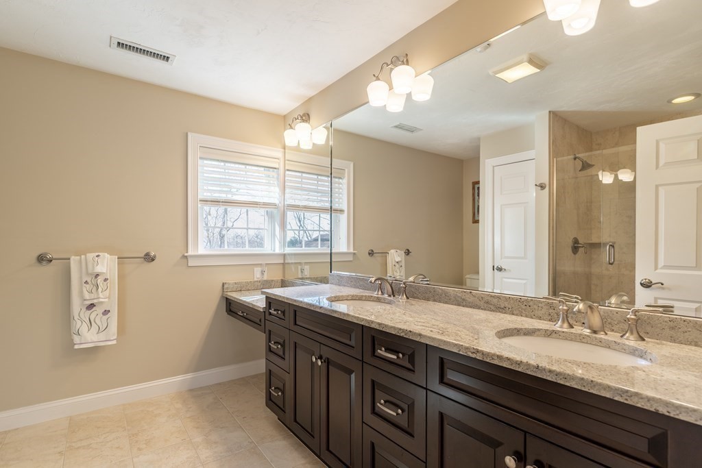 22 English Commons: 12 Boston Street, Unit 22 Topsfield, MA 01983 - Photo 22 of 41 a bathroom with a granite countertop sink mirror and double