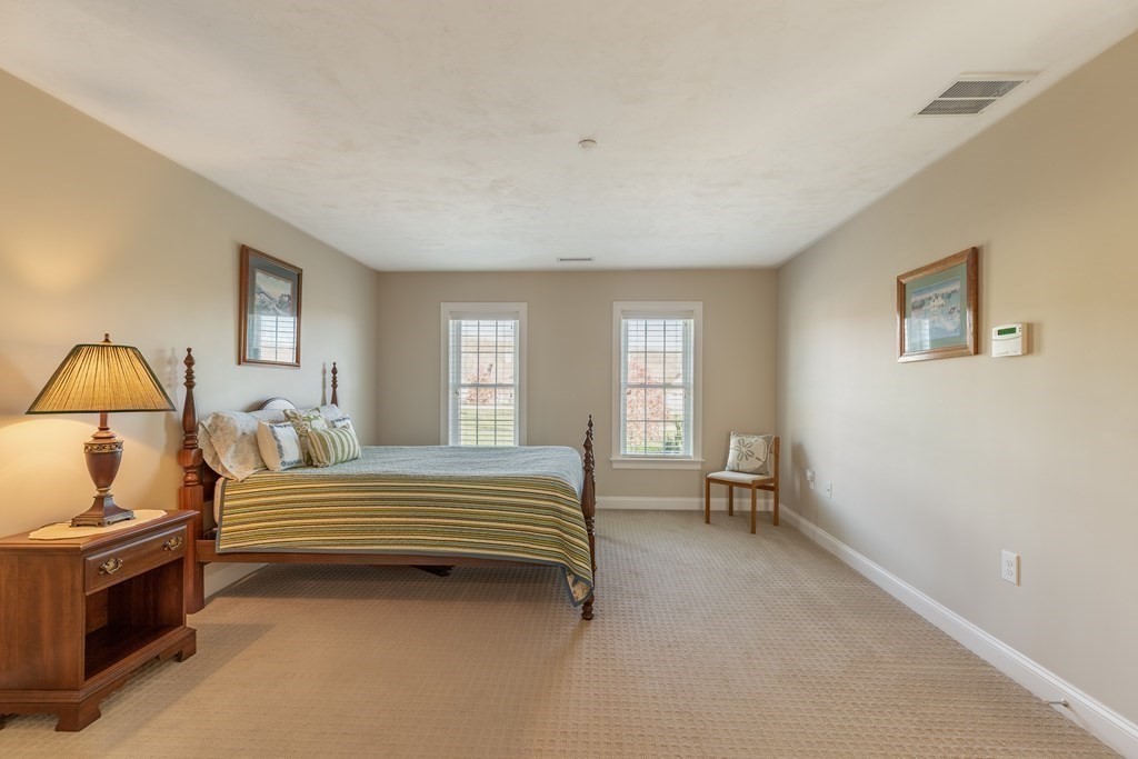 22 English Commons: 12 Boston Street, Unit 22 Topsfield, MA 01983 - Photo 25 of 41 a bedroom with a bed and a window