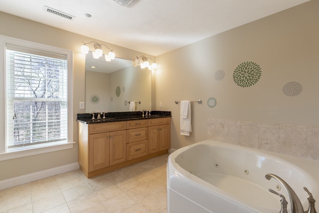 22 English Commons: 12 Boston Street, Unit 22 Topsfield, MA 01983 - Photo 27 of 41 a bathroom with a bathtub sink and mirror