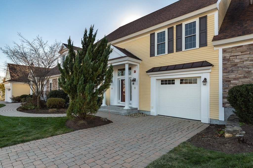 22 English Commons: 12 Boston Street, Unit 22 Topsfield, MA 01983 - Photo 3 of 41 a front view of a house with a yard and garage