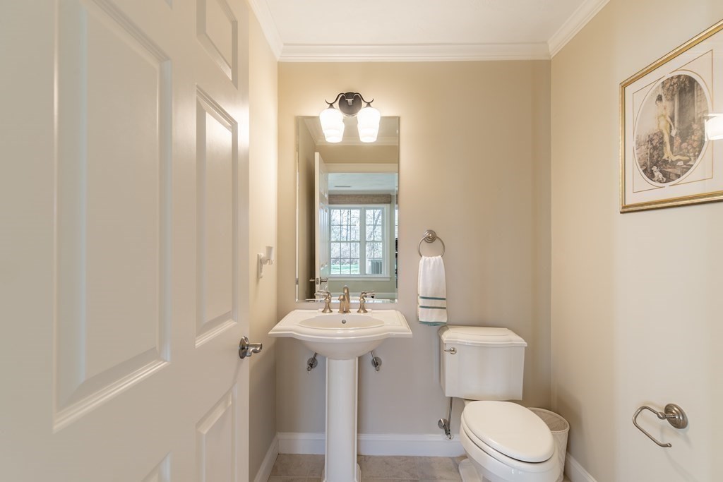 22 English Commons: 12 Boston Street, Unit 22 Topsfield, MA 01983 - Photo 31 of 41 a bathroom with a sink mirror and toilet