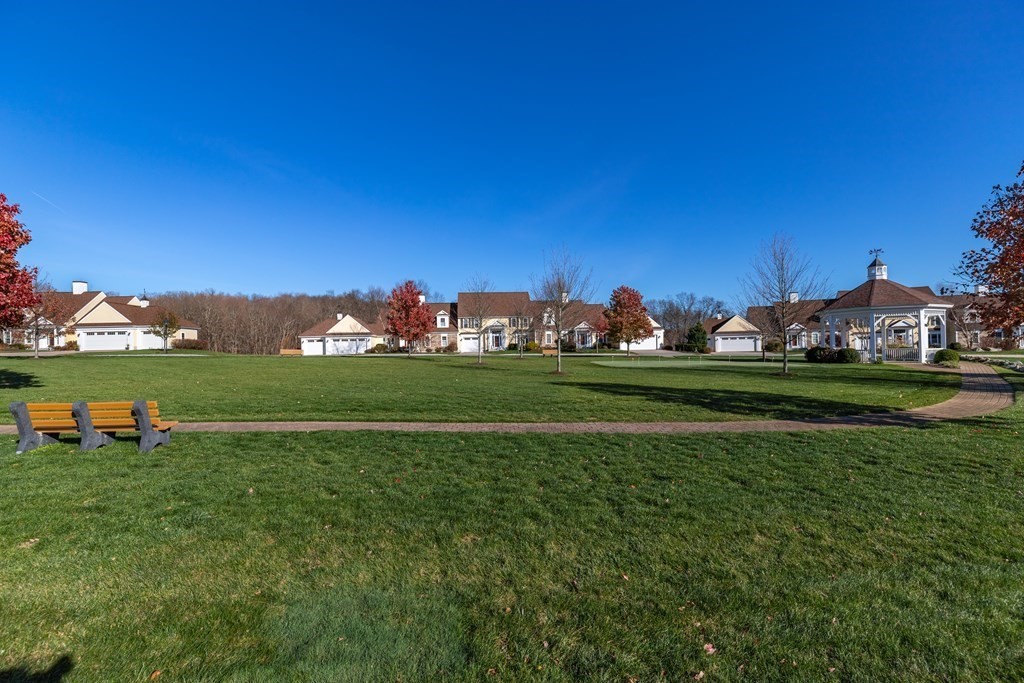22 English Commons: 12 Boston Street, Unit 22 Topsfield, MA 01983 - Photo 37 of 41 a backyard of a house with lots of green space