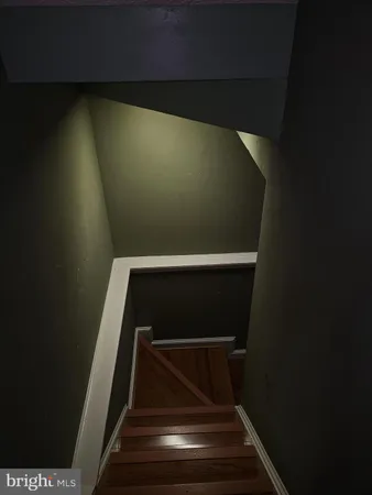 a living room with wooden floor and furniture