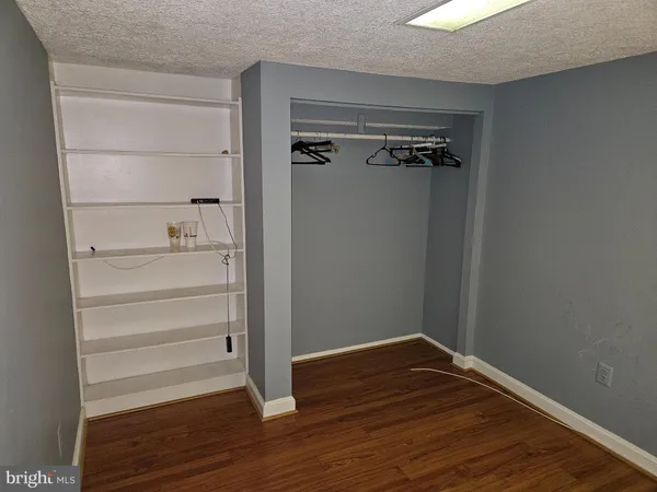 a bathroom with a toilet mirror vanity and a sink