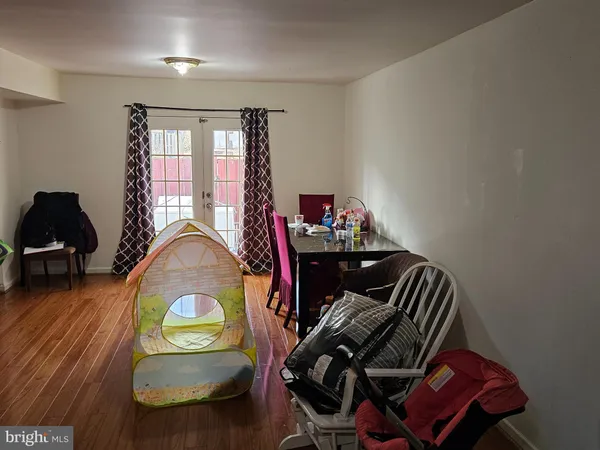 a room with a refrigerator and a window