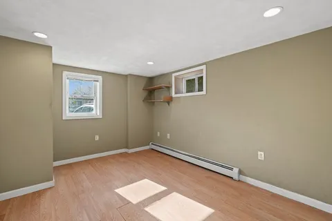 a view of room with stairs and wooden floor
